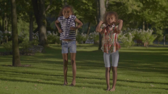 Two Smiling Little Sisters Dancing Hip Hop Outdoors alt