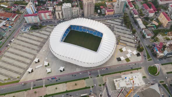 Aerial hyperlapse of Dinamo Batumi Stadium near Heroes Square against cityscape