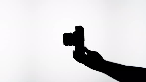 Shadow of Photo Camera on White Background