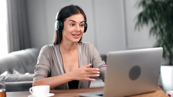 Woman in Headphones Gesticulating Talking Webcam Video Call Use Laptop