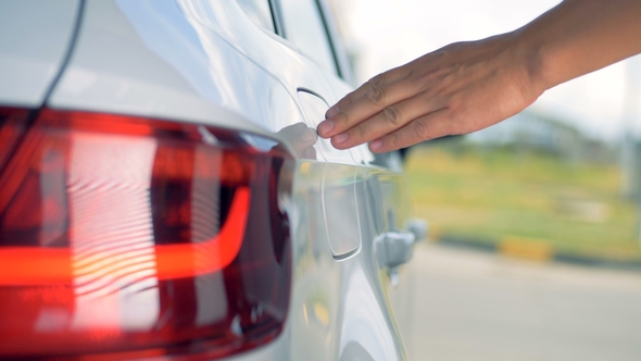 A Man Fuels His Car