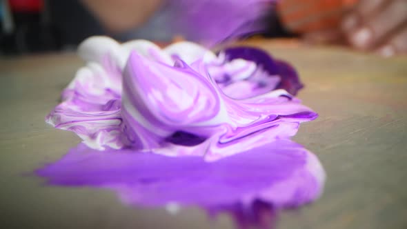 Closeup Shot of Artist Holding Paint Brush and Mix Color on Wooden Palette