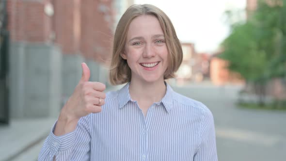 Portrait of Woman Showing Thumbs Up Sign Outdoor