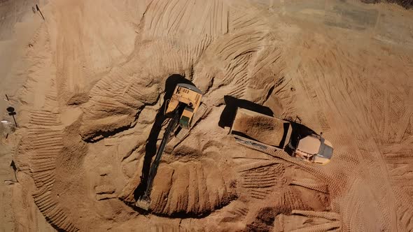 Top Down View of Excavator Working in Construction Site alt