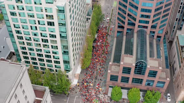 Protesters Marching in the Streets of Vancouver Downtown, Aerial Orbiting View. Indigenous people in