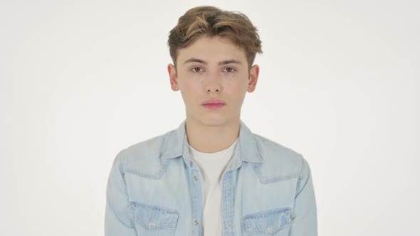 Serious Young Man Looking at the Camera on White Background