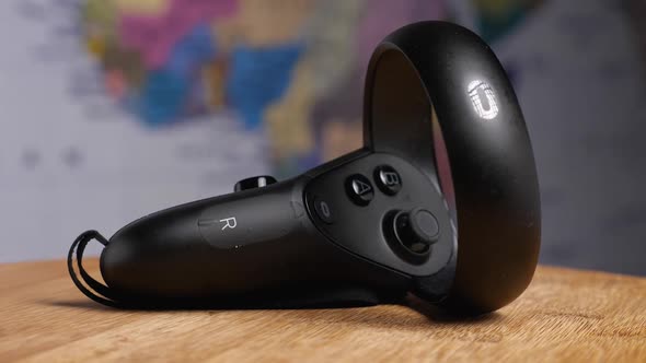 Close-up of a virtual reality glasses controller lying on a wooden background