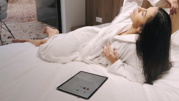 Attractive Young Woman Holding Tablet Home