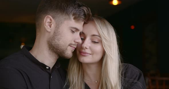 Beautiful People Man and Woman Hugging at Restaurant