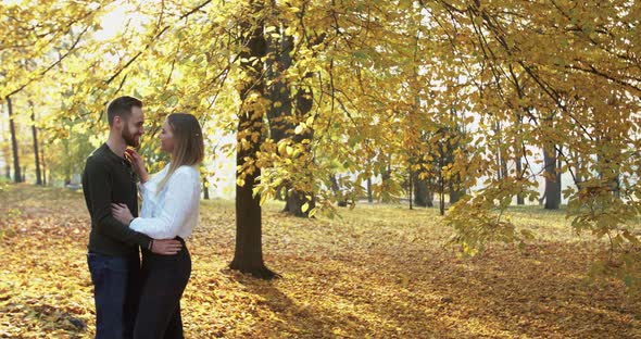 Lovely Couple Admires of Each Other and Caresses in Embraces in Autumn