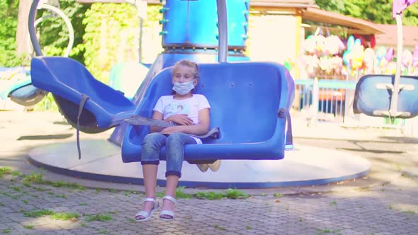 Girl Wearing a Protective Mask Sitting