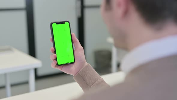 Rear View of Man Looking at Smartphone with Chroma Screen