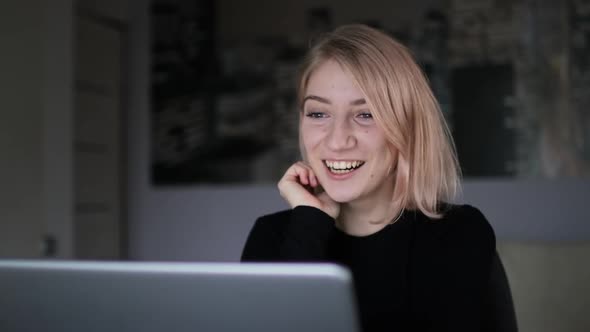 Young Pretty Woman Smiling and Chatting Via Video Call on Laptop at Home