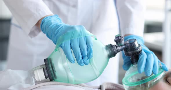 Doctor Holding Oxygen Mask in Emergency Room Closeup