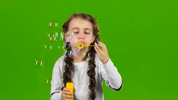 Child with Soap Bubbles. Green Screen