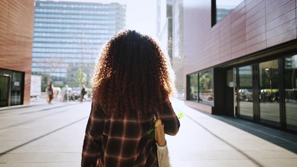 Back View of African American Girl with Sensual Lips and Piercing Going Home From the Market with