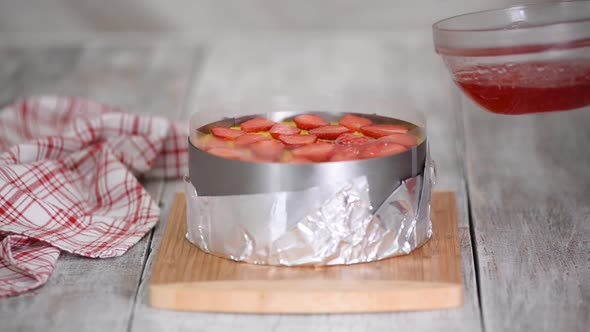 The Cook Pours the Top Layer Strawberry Cake with Jelly