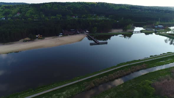 Tourist European City. Beautiful Valley, Lake, Long Beach, Forest, Wooden Pier.