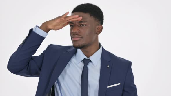 African Businessman Looking Around Searching on White Background