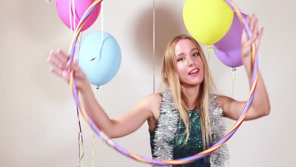 Slow motion of young woman with hula hoop in photo booth