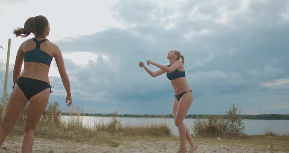 Lady Beach Volleyball Players Are Passing Ball and Attacking, Friendly Match of Two Female Teams at