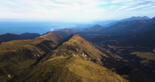 Aerial reveal shot of beautiful misty Mt Alexander, Seaward Kaikoura Range. Kaikoura.