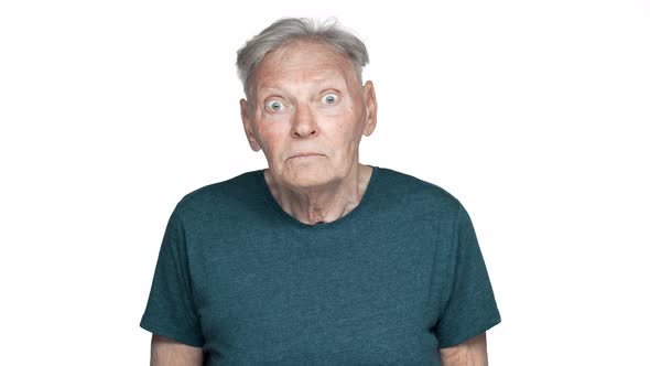 Portrait of Shocked Old Aged Man 80s Having Gray Hair in Basic Tshirt Expressing Fear or Anxiety