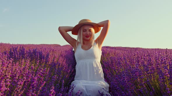 Portrait of a Blonde Woman with Hat in Lavender Fields on Summer