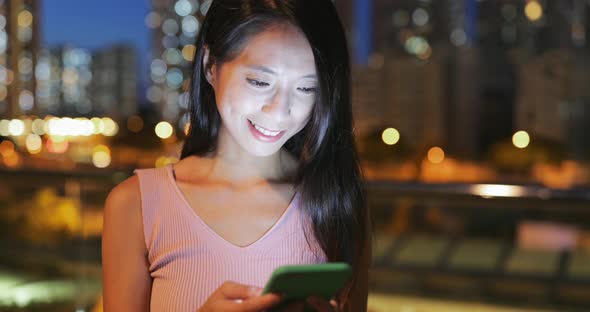 Woman use of mobile phone at night 