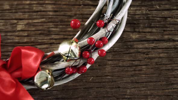 Grapevine wreath with ribbon on wooden table