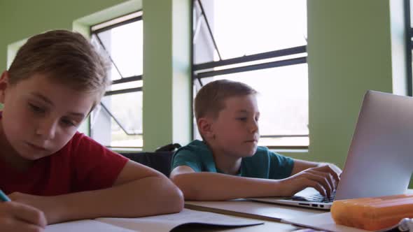 Boy using laptop in the class