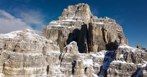 Wonderful slide view of Tre Cime di Lavaredo during winter. Filmed in high quality with DJI Mavic 3