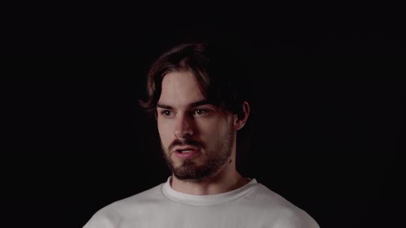 Trendy Young Man annoyed reaction, rolling eyes, close, black background