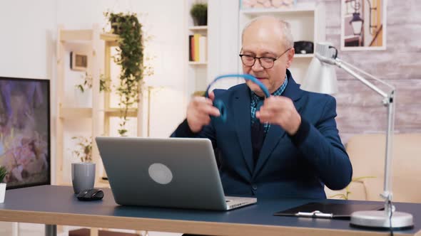 Senior Old Man Listening Music on Headphones