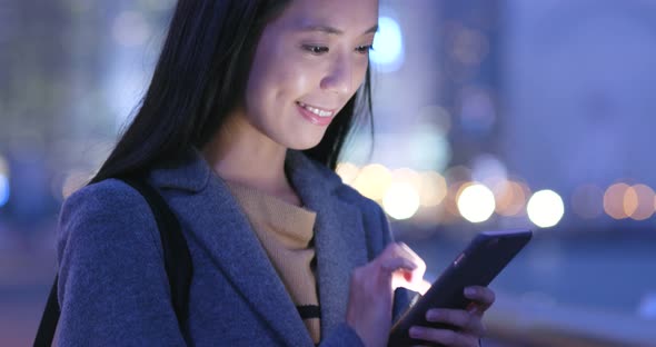 Woman use of cellphone at night