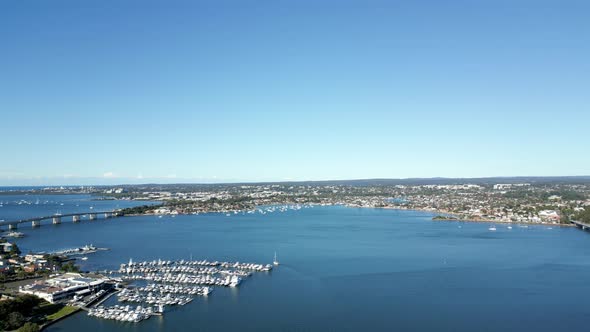 Ocean waterfont properties with boats marina. Beautiful aerial view featuring the blue sky and capta
