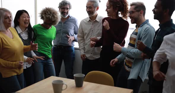 Dancing multiracial people having fun together at home kitchen