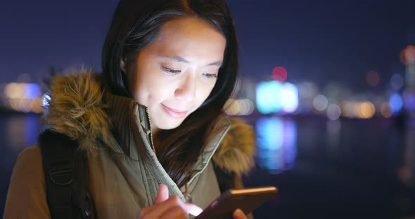 Young Woman Use of Smart Phone in City at Night