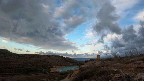 Beautiful fluffy clouds over the Lippija tower and Gnejna bay timelapse