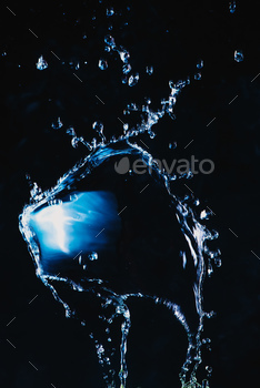 ng transparent liquid with a shiny surface. High-speed explosion photography.