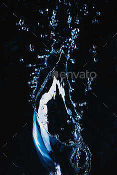 ng transparent liquid with a shiny surface. High-speed explosion photography.