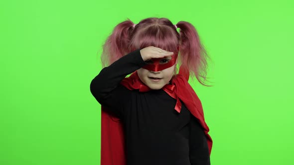 Funny Child Girl in Costume and Mask Plays Super Hero. National Superhero Day