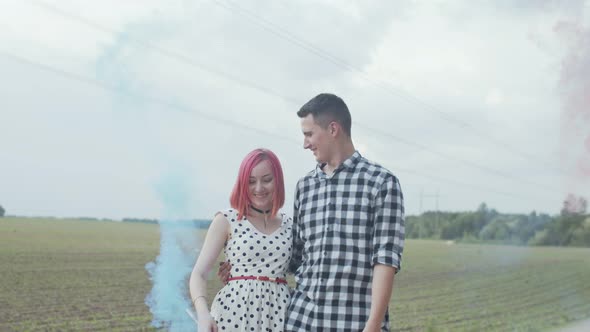 Happy Couple Showing Smoke Heart in Countryside