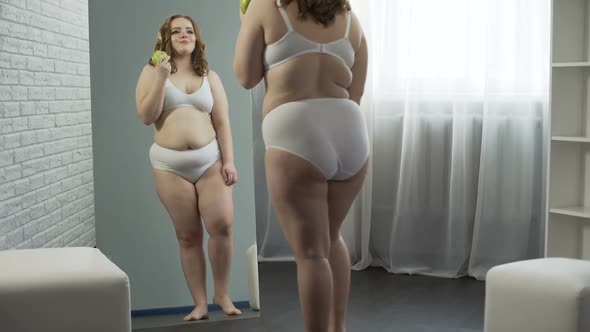 Plump Girl Eating Healthy Food, Watching Her Progress in Losing Weight, Dieting