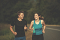 young couple jogging along a country road - PhotoDune Item for Sale