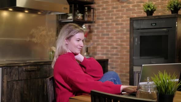 Freelance businesswoman sits desk typing on laptop and drinking morning coffee