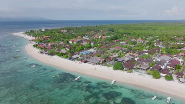 Tropical tourist destination with white sand beach and resorts on shore, Pantai Pasir Putih, aerial