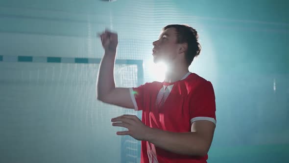 Young Football Player Performs Tricks with a Soccer Ball Balances the Ball on Her Head