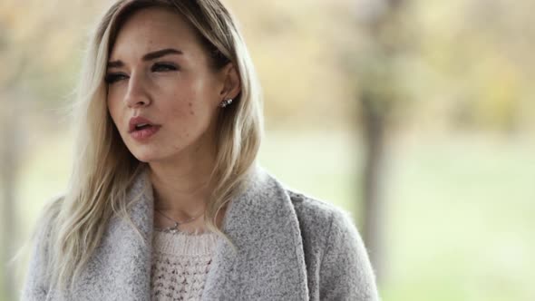 Young Beautiful Business Woman Smoking a Cigarette in the Park