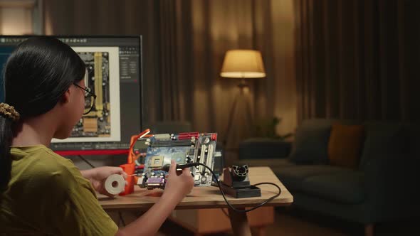 It Girl Is Soldering Electronic Circuit And Works With Computer In Home, Display Show Cad Software